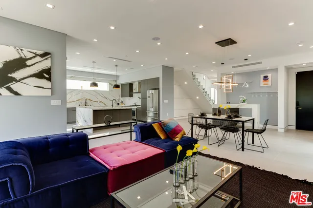 a bedroom with a bed and a potted plant