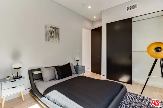 a bedroom with a bed and a walk in closet