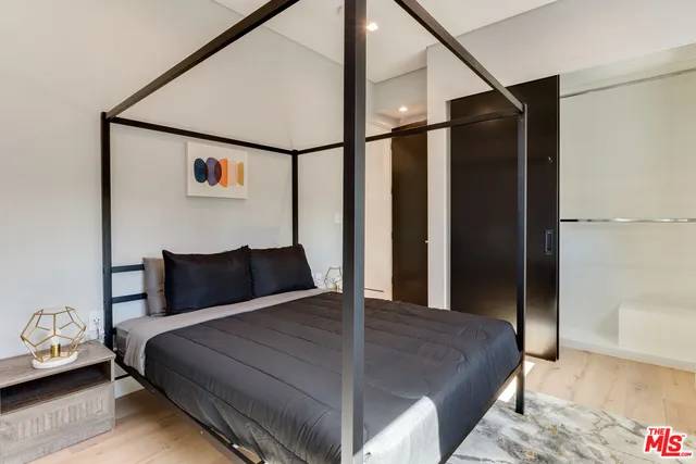 a living room with a couch a table and wooden floor