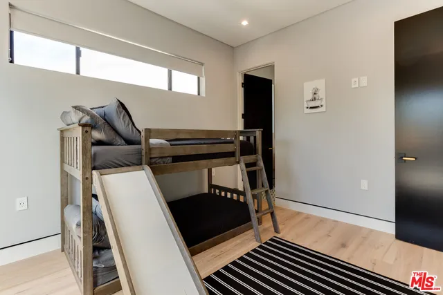 a bedroom with a bed and a television