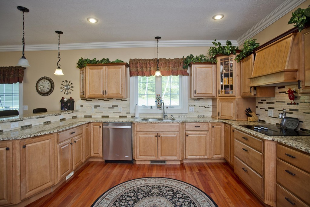 676 Old Warren Road Palmer, MA 01069 - Photo 11 of 30 a kitchen with granite countertop a sink stove and cabinets