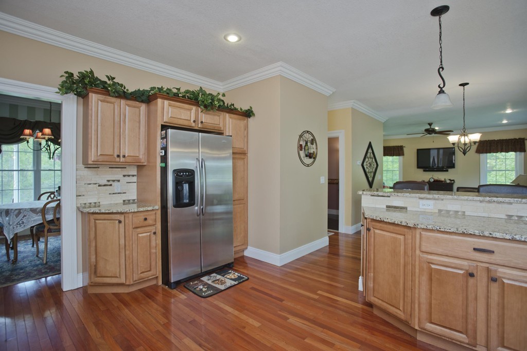 676 Old Warren Road Palmer, MA 01069 - Photo 12 of 30 a kitchen with stainless steel appliances granite countertop a refrigerator a stove and a wooden floors