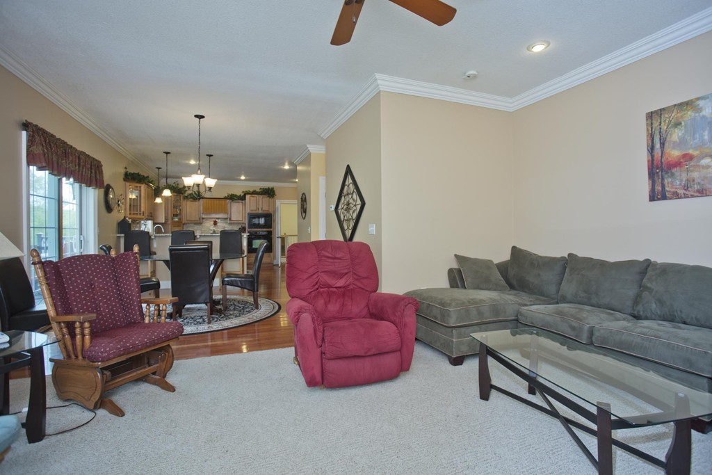 676 Old Warren Road Palmer, MA 01069 - Photo 15 of 30 a living room with furniture and a chandelier