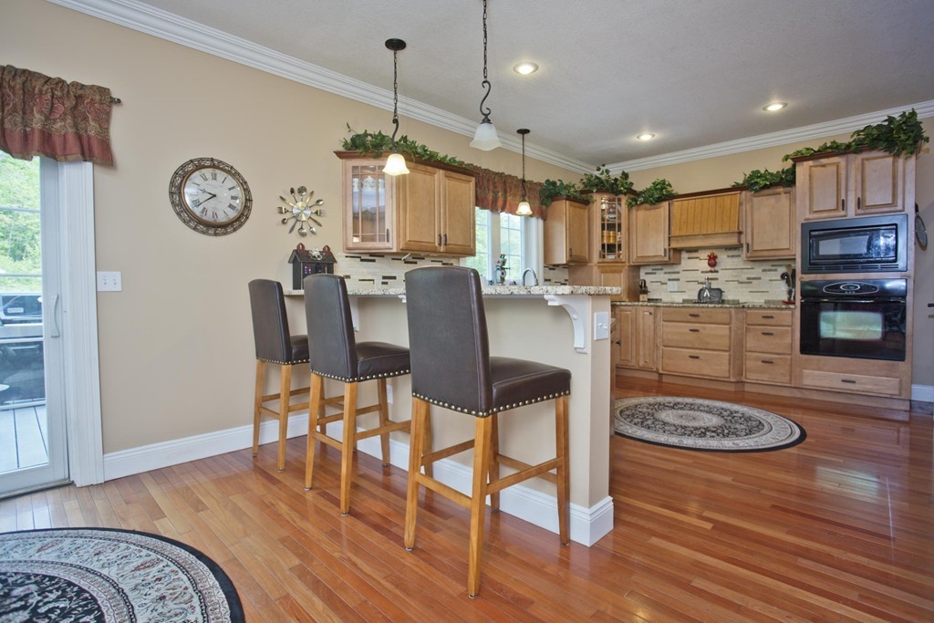 676 Old Warren Road Palmer, MA 01069 - Photo 16 of 30 a large kitchen with a table and chairs