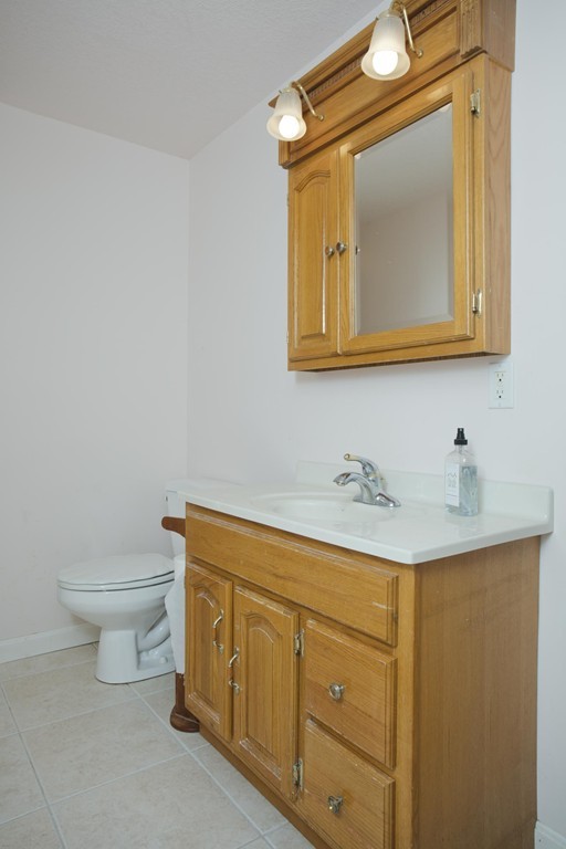 676 Old Warren Road Palmer, MA 01069 - Photo 19 of 30 a bathroom with a toilet sink and mirror