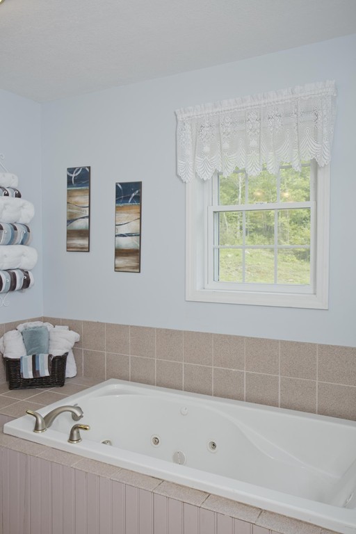 676 Old Warren Road Palmer, MA 01069 - Photo 21 of 30 a bathroom with a bathtub and a window
