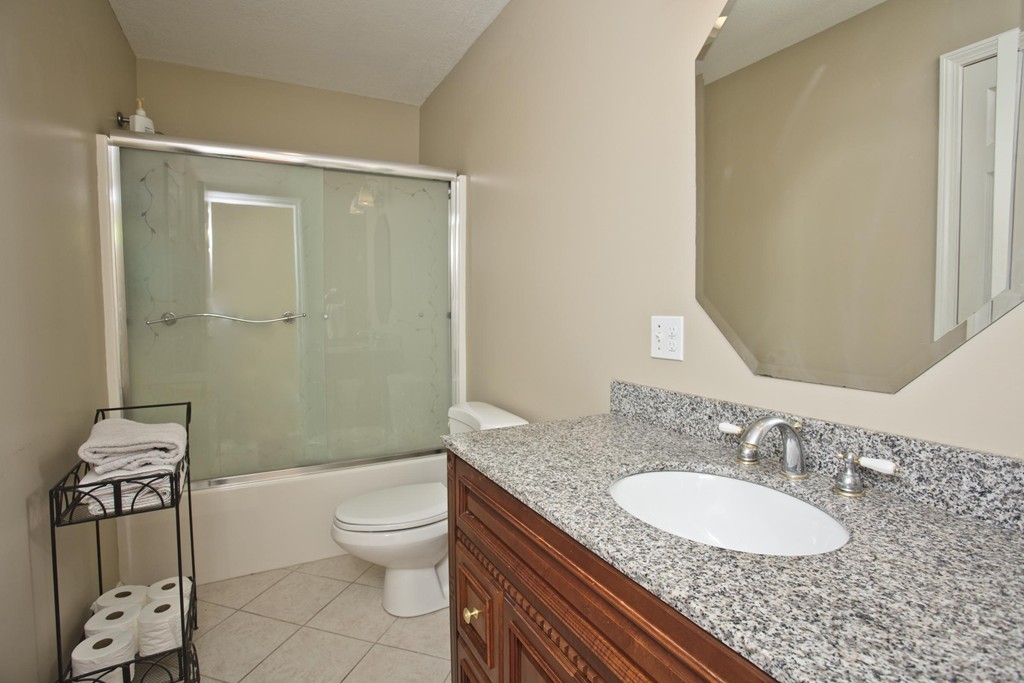 676 Old Warren Road Palmer, MA 01069 - Photo 24 of 30 a bathroom with a granite countertop sink toilet a mirror and shower