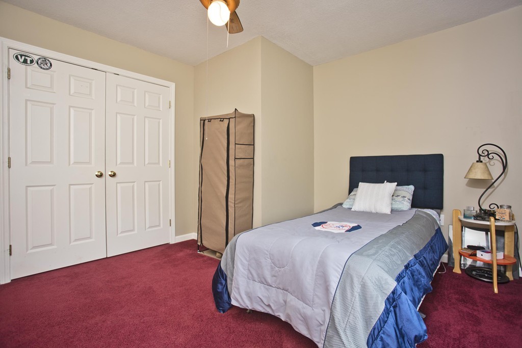676 Old Warren Road Palmer, MA 01069 - Photo 26 of 30 a bedroom with a bed a table and painting