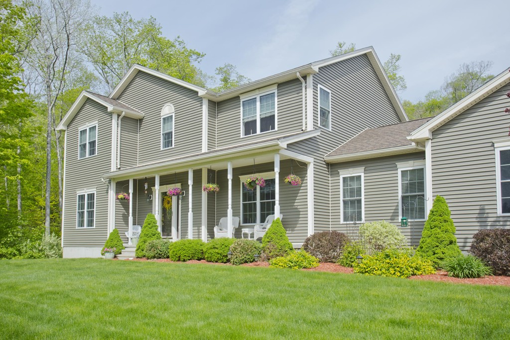 676 Old Warren Road Palmer, MA 01069 - Photo 28 of 30 a front view of a house with a yard and potted plants