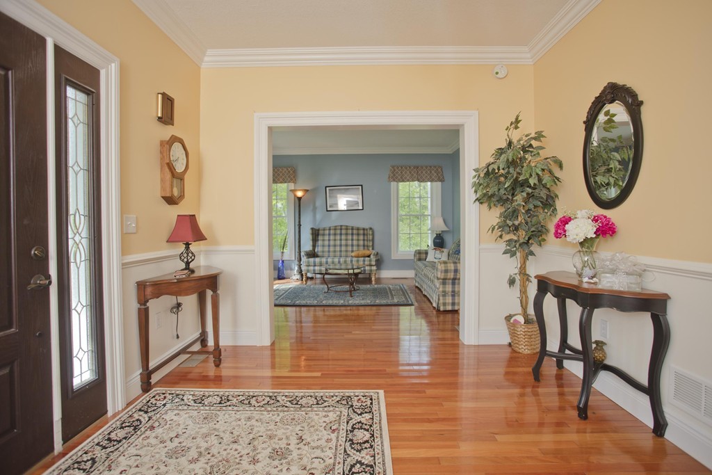 676 Old Warren Road Palmer, MA 01069 - Photo 3 of 30 a living room with furniture and a chandelier