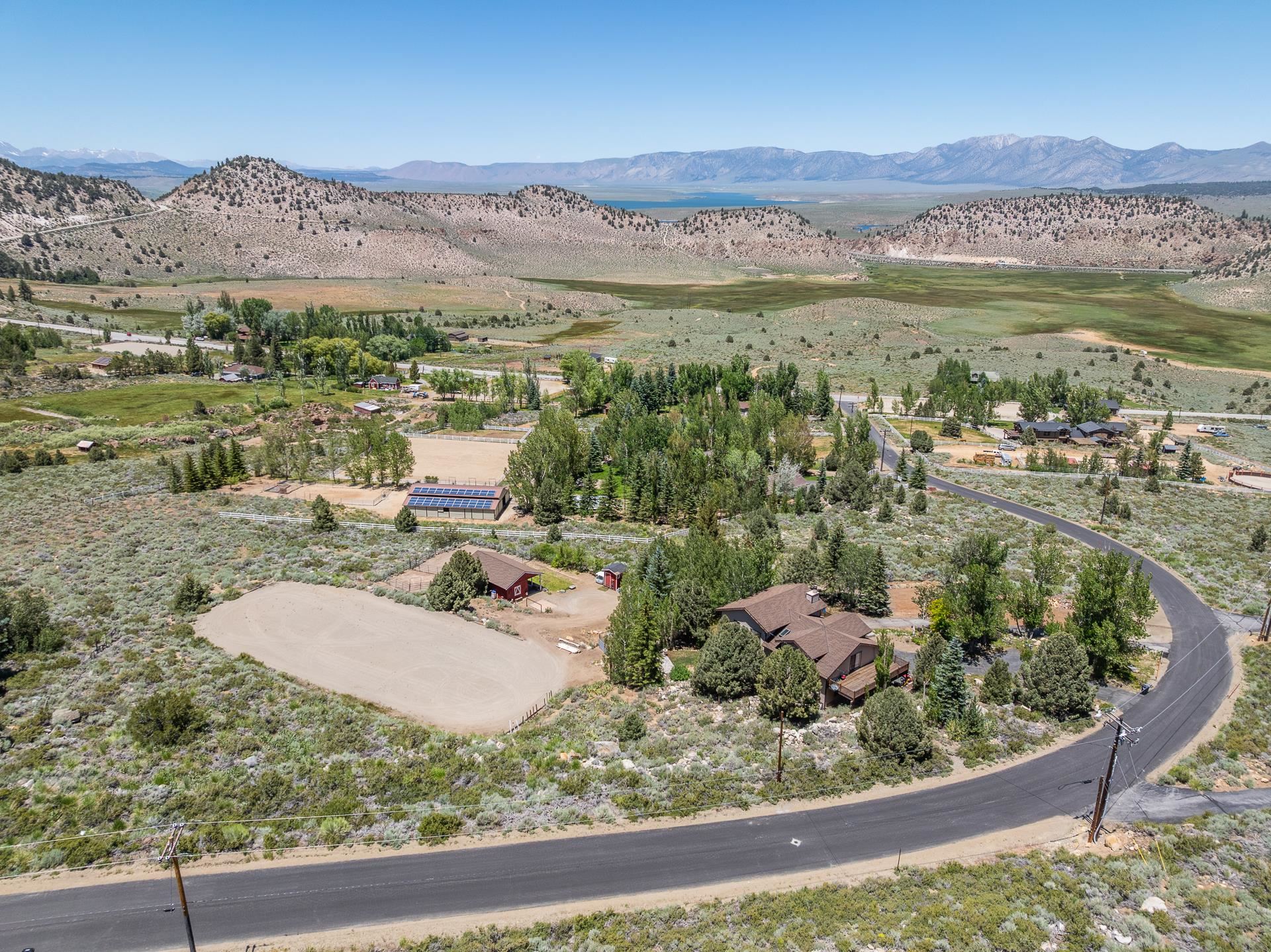 537 Aspen Spring Ranch Road Mammoth Lakes, CA 93546 - Photo 39 of 40 Sprawling property featuring a multi-level residence with a brown shingle roof, surrounded by mature trees and native landscaping