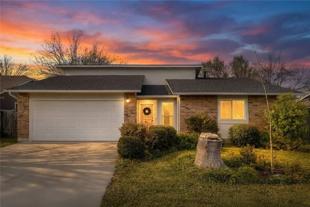 a front view of a house with yard and mountain view