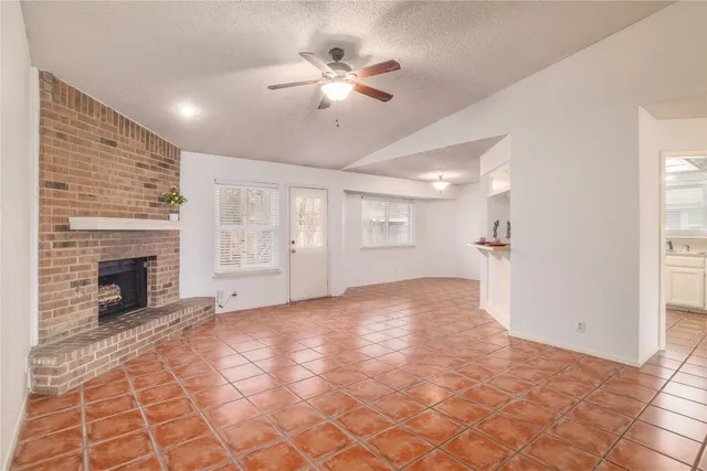 a view of an empty room with a fireplace