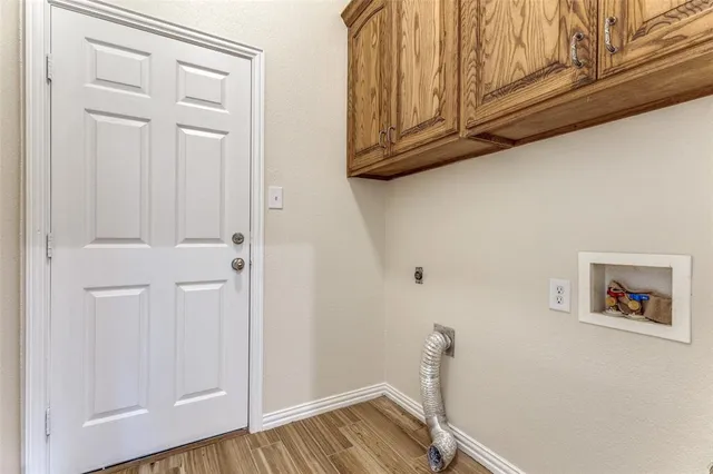 a view of a room with wooden floor and cabinet