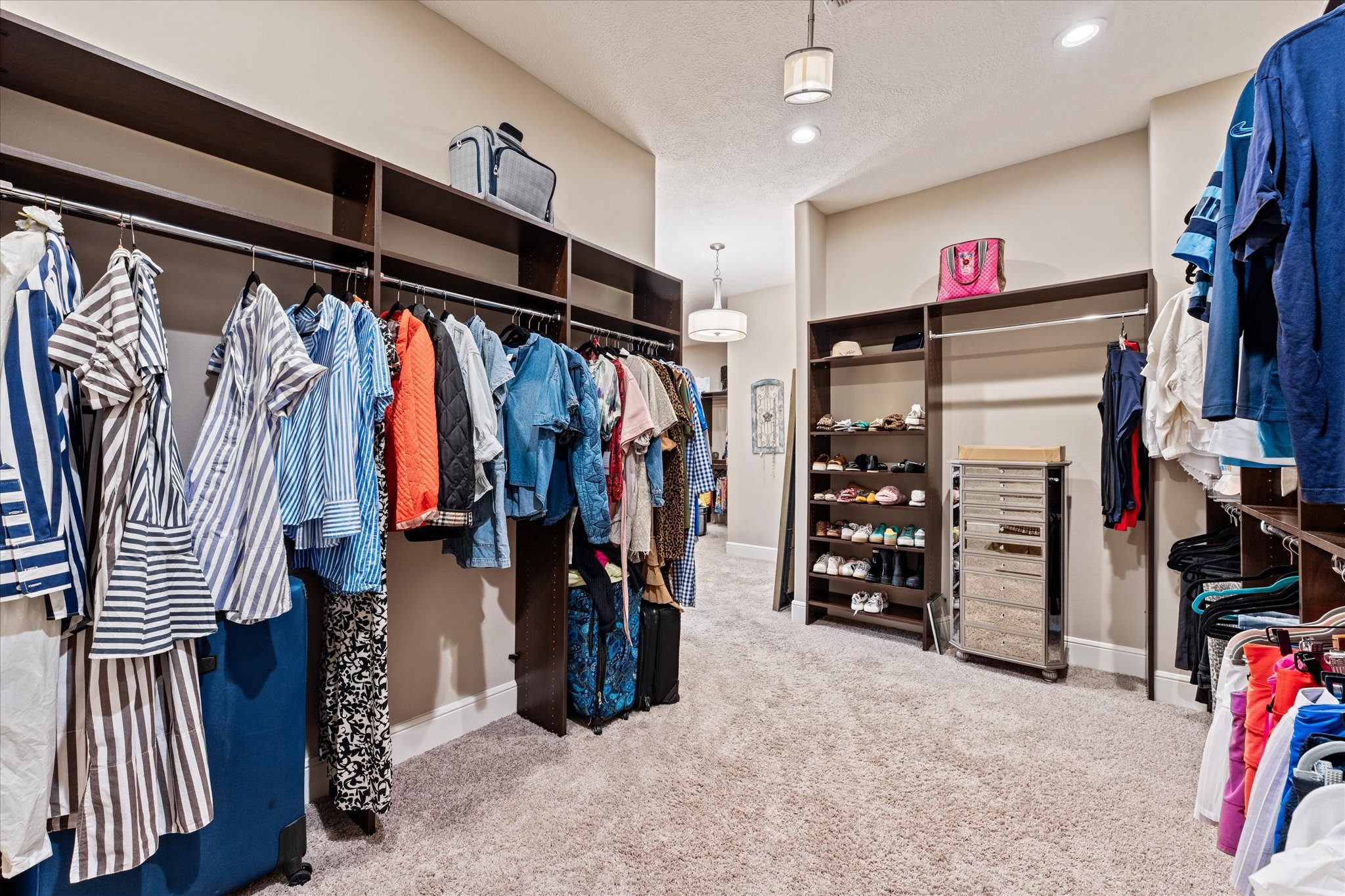 30618 Spring Lake Boulevard Tomball, TX 77375 - Photo 31 of 50 One side of the primary bedroom closet. Go shopping, this closet can handle all of your clothing purchases.
