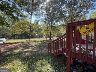 128 West Lakeview Drive Temple, GA 30179 - Photo 19 of 20 a view of a wooden house with a small yard and wooden fence