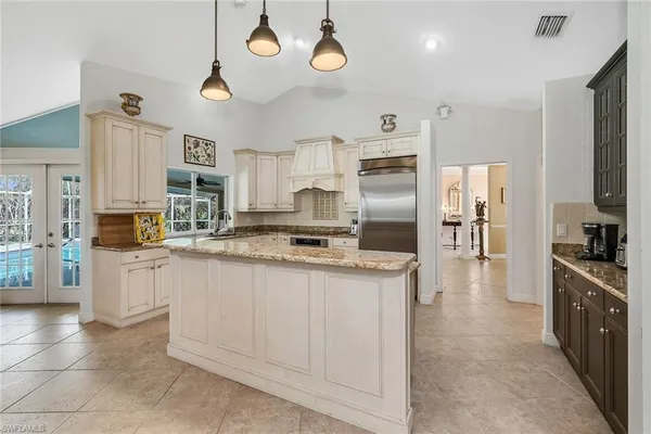 a kitchen with stainless steel appliances a stove refrigerator sink and cabinets