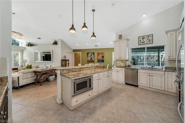 a kitchen with a stove a sink and a refrigerator
