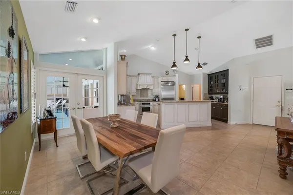 a large kitchen with sink and refrigerator