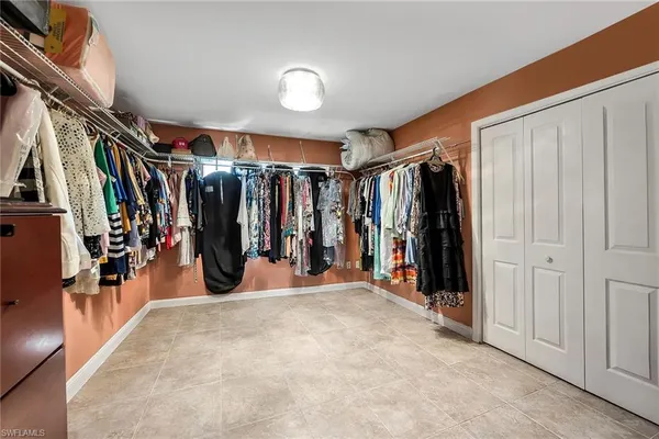 a view of a living room with walk in closet and a window