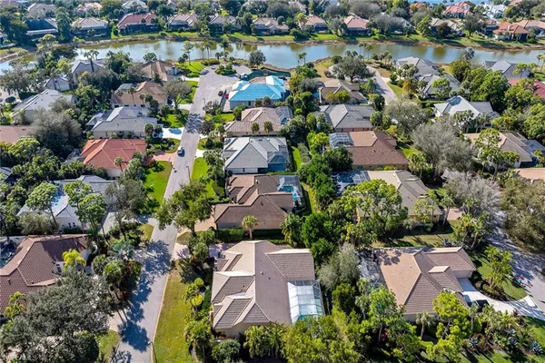 an aerial view of residential house with outdoor space and lake view