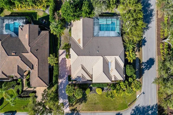 an aerial view of a house with a garden and trees