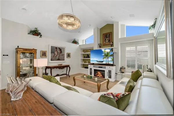a living room with fireplace furniture and a flat screen tv