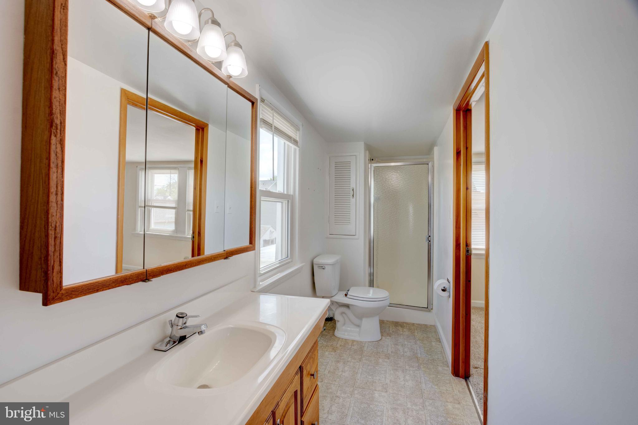 625 Hammonds Lane Baltimore, MD 21225 - Photo 18 of 40 a bathroom with a sink and a mirror