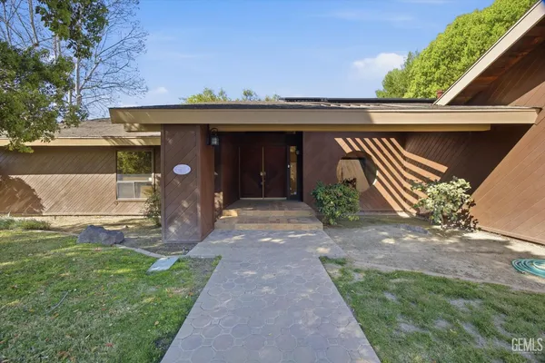 a front view of house with yard and green space