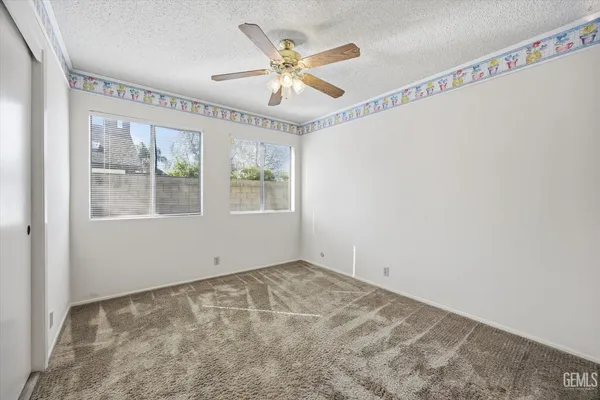 a open kitchen with stainless steel appliances granite countertop a stove and a refrigerator