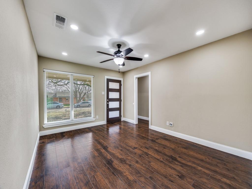 8911 Angleton Place Dallas, TX 75243 - Photo 2 of 12 a view of an empty room with a window and wooden floor