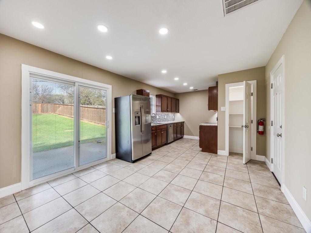 8911 Angleton Place Dallas, TX 75243 - Photo 3 of 12 a open kitchen with stainless steel appliances granite countertop a refrigerator and a sink