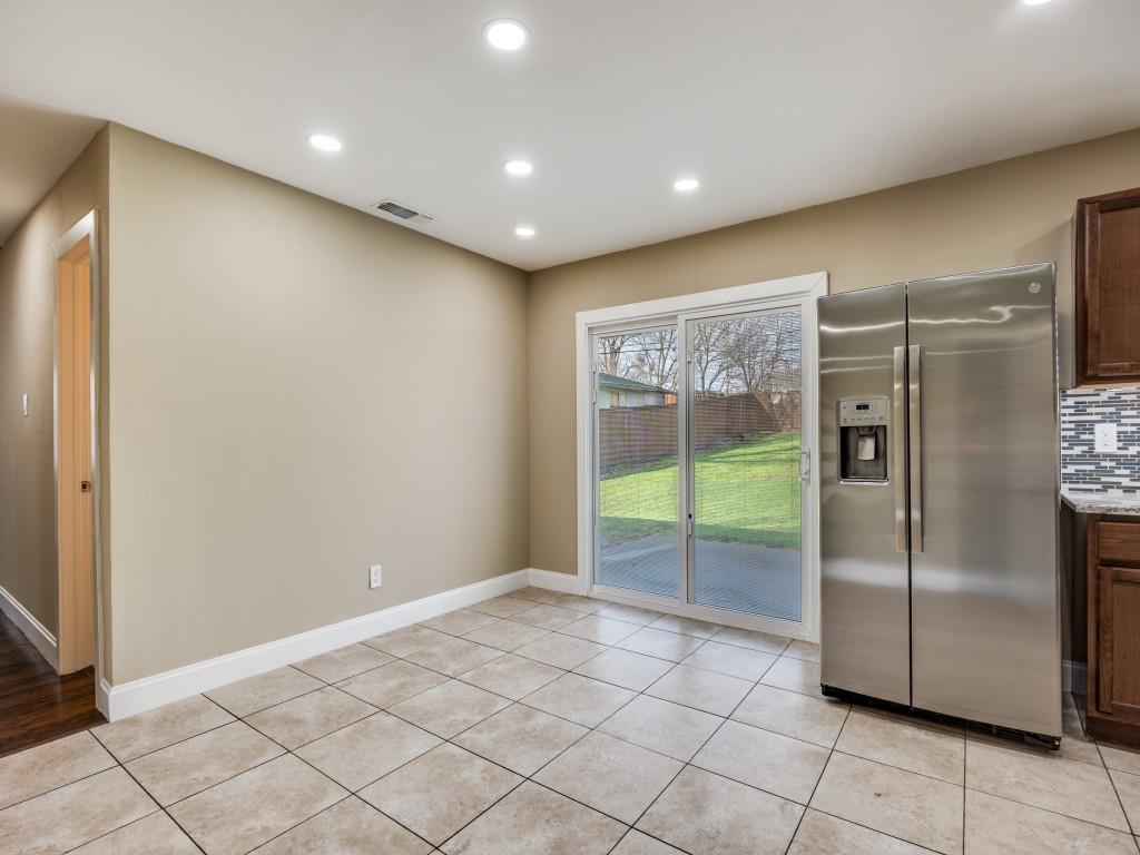 8911 Angleton Place Dallas, TX 75243 - Photo 4 of 12 a view of an empty room with a fireplace