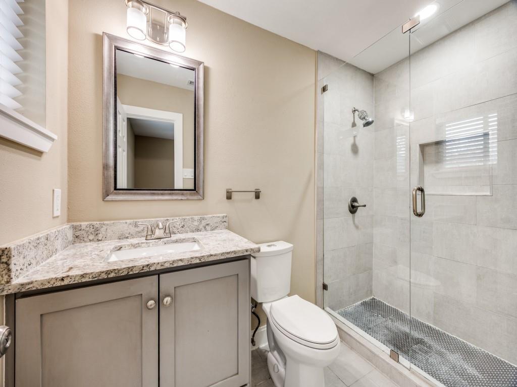 8911 Angleton Place Dallas, TX 75243 - Photo 6 of 12 a bathroom with a granite countertop toilet sink and a mirror