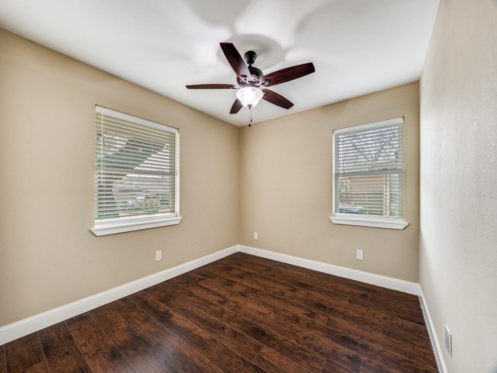 8911 Angleton Place Dallas, TX 75243 - Photo 8 of 12 a view of an empty room with wooden floor and a window