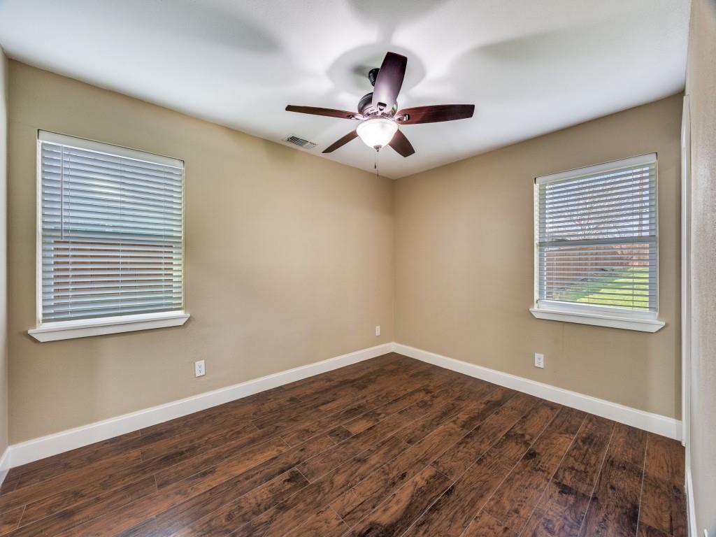 8911 Angleton Place Dallas, TX 75243 - Photo 10 of 12 a view of empty room with wooden floor and fan
