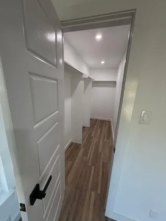 a view of hallway with wooden floor