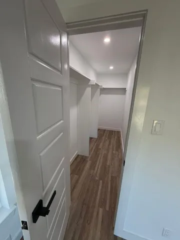 a view of hallway with wooden floor
