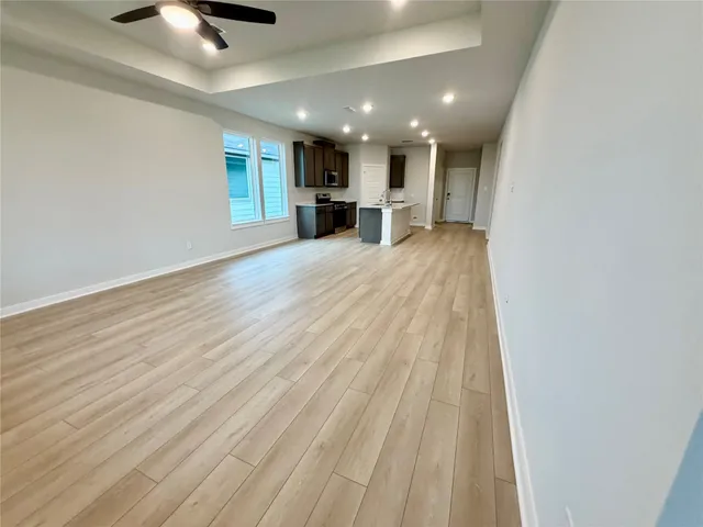 a view of kitchen with sink and refrigerator