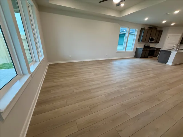 a view of a room with wooden floor and stairs