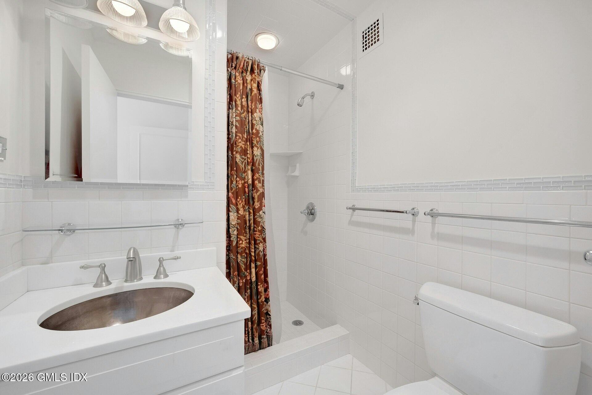 630 Steamboat Road, Unit 4AN Greenwich, CT 06830 - Photo 23 of 32 a bathroom with a sink a toilet and shower