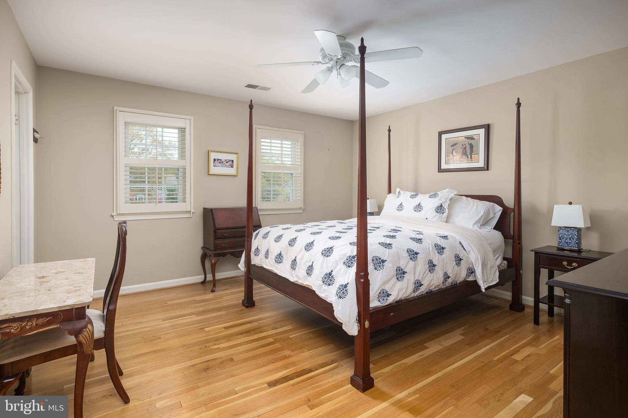 6311 Golf Course Square Alexandria, VA 22307 - Photo 12 of 39 a bedroom with a bed a table and chair with a bookshelf