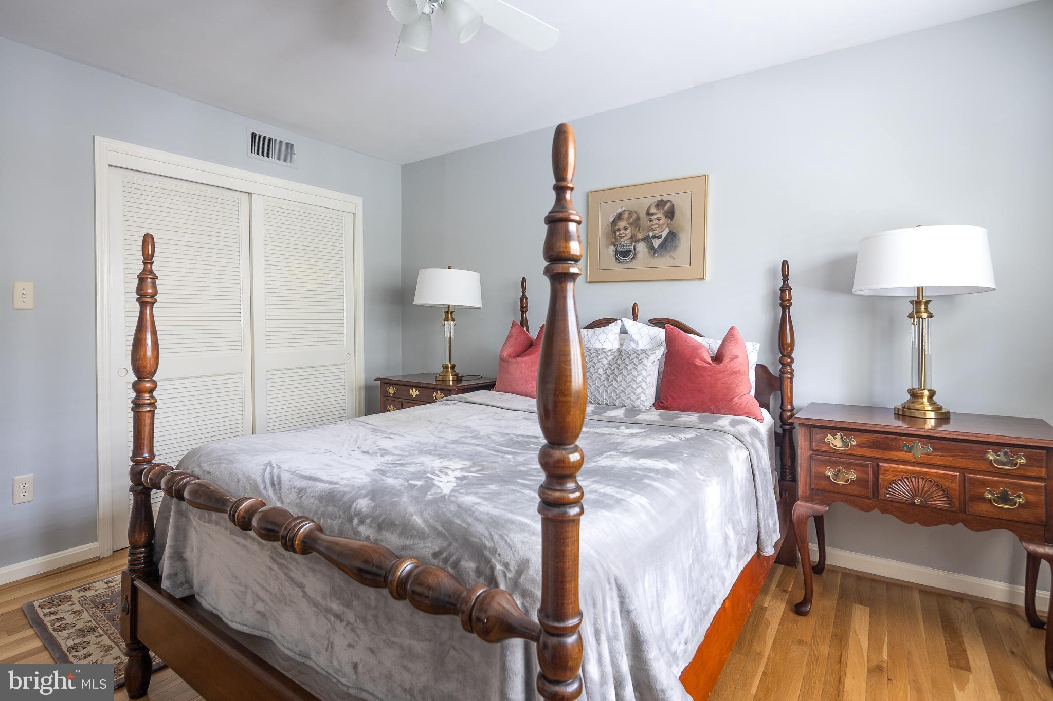6311 Golf Course Square Alexandria, VA 22307 - Photo 17 of 39 a bedroom with a bed and a lamp on table