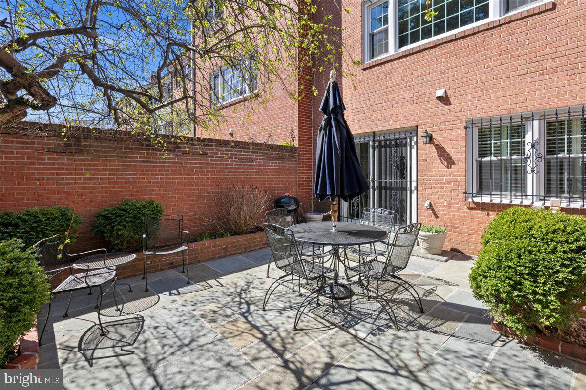 6311 Golf Course Square Alexandria, VA 22307 - Photo 28 of 39 a view of a patio with table and chairs with wooden fence and plants
