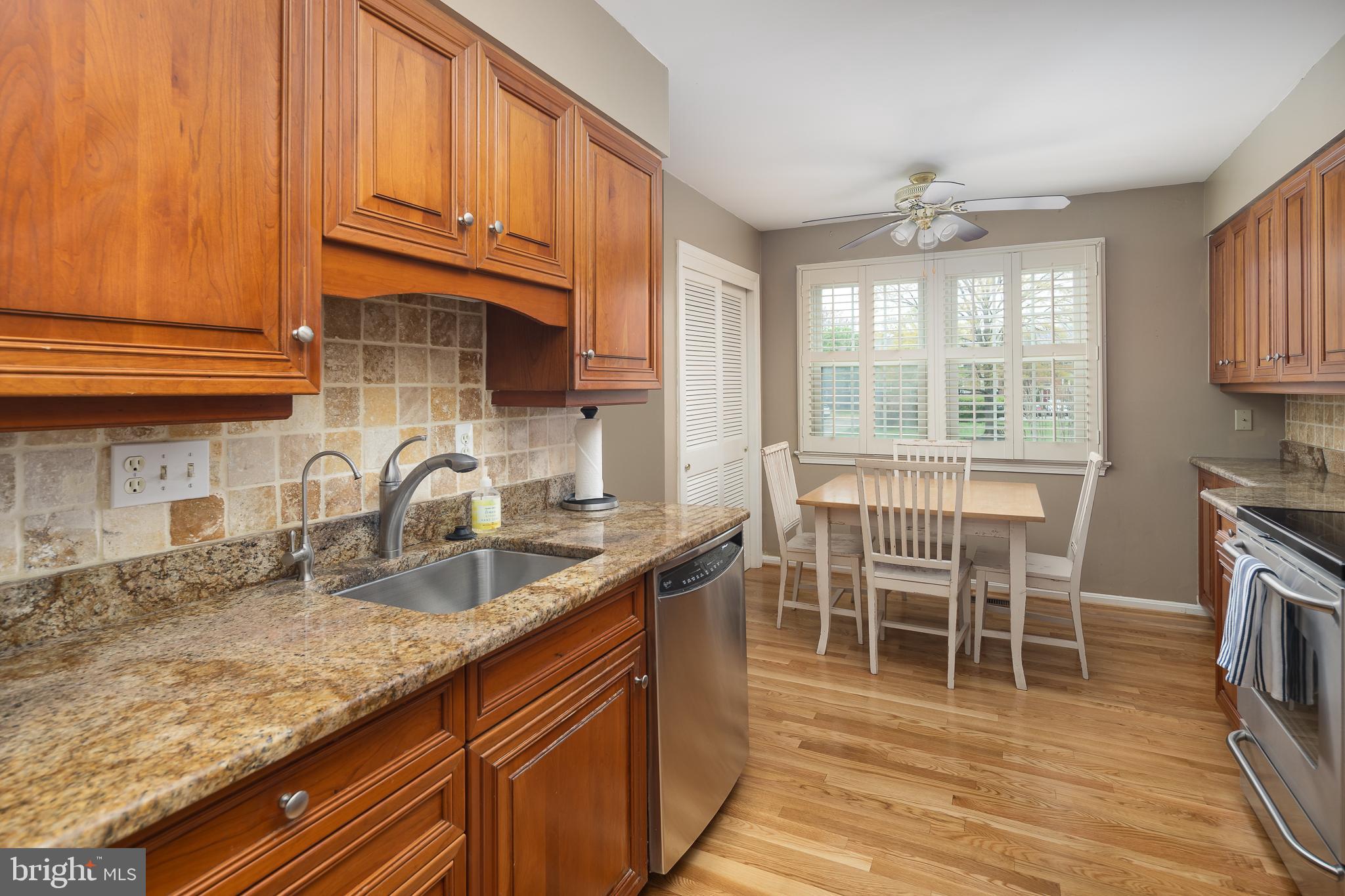 6311 Golf Course Square Alexandria, VA 22307 - Photo 5 of 39 a kitchen with granite countertop a sink stove and cabinets