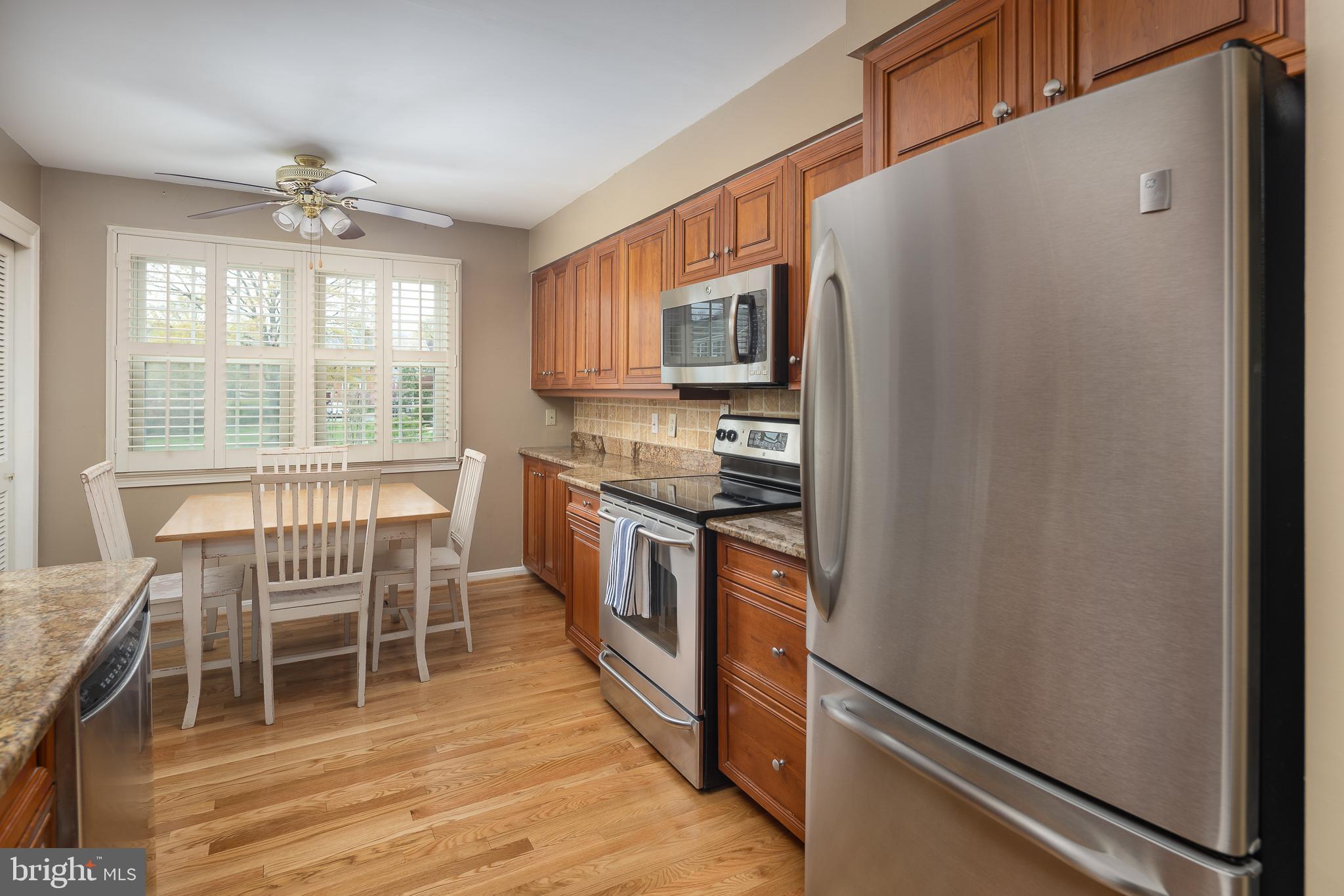 6311 Golf Course Square Alexandria, VA 22307 - Photo 6 of 39 a kitchen with stainless steel appliances granite countertop a refrigerator and a stove top oven