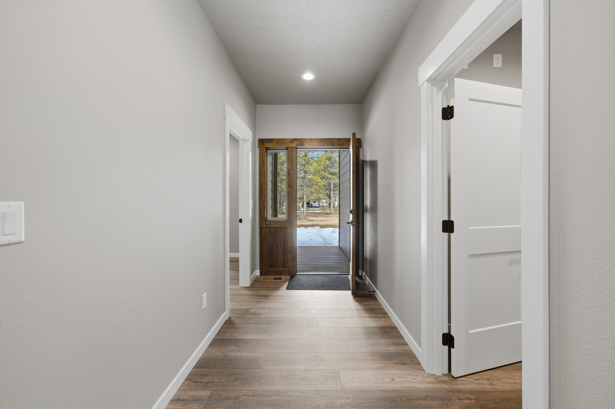 16083 Dyke Road, Unit 9 La Pine, OR 97739 - Photo 4 of 53 a view of a hallway with wooden floor and closet