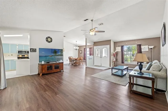 a living room with furniture and kitchen view