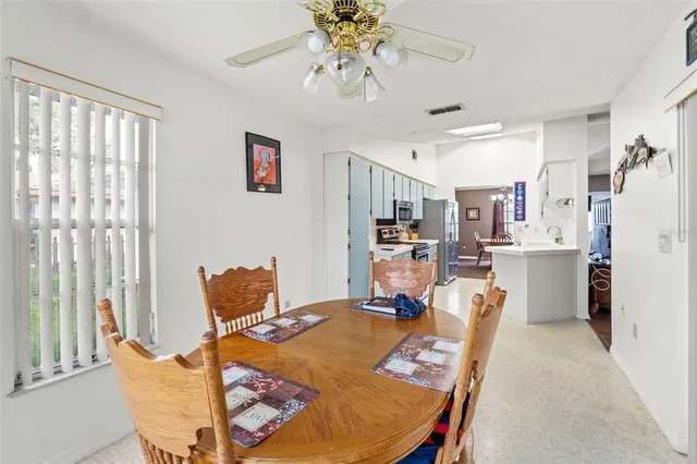 a view of a dining room with furniture and a chandelier