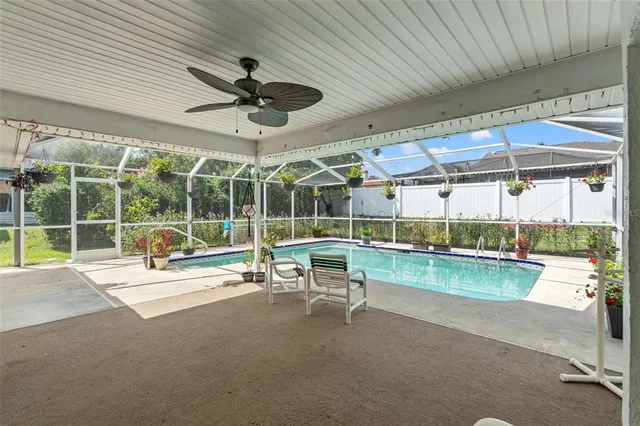 a view of a patio with a table and chairs under an umbrella